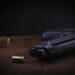 gun with a bullet on a wooden table