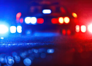 Blurred background of police flashing lights at the crime scene