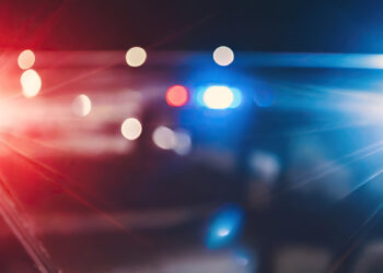 Blurred background of police flashing lights at the crime scene