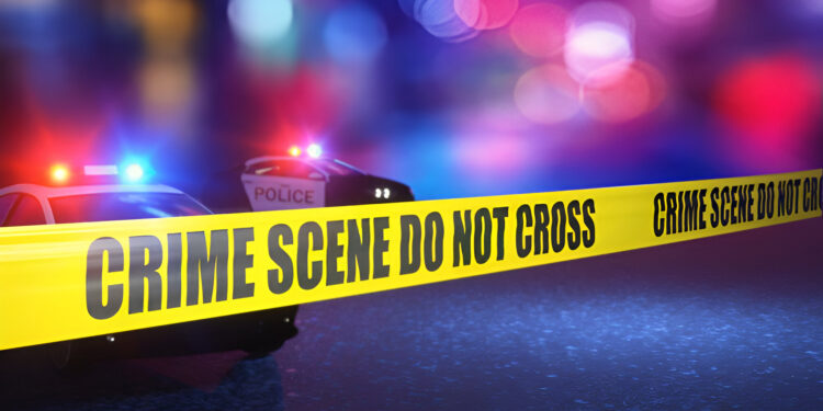 crime scene do not cross with line police car in the back