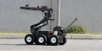 Terrorism. Bomb. Robot. A robot disarm a bomb inside a car of terrorists. Bomb squad robot.