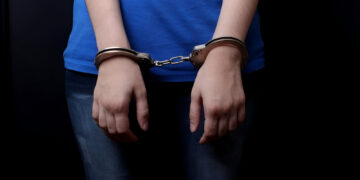 men and women cuffed hands together