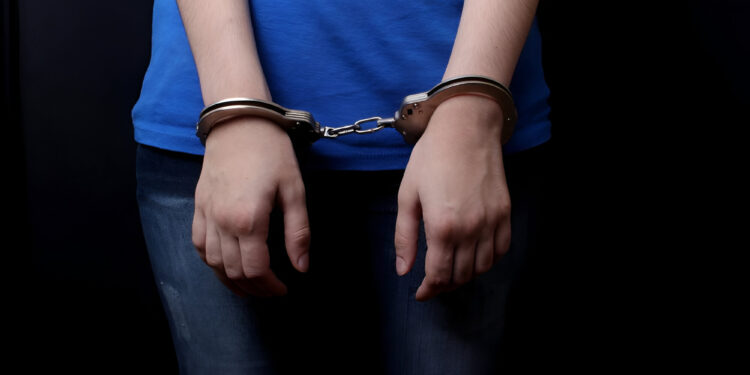 men and women cuffed hands together