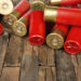 red hunting cartridges for shotgun on wooden background. Macro shot