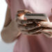 Midsection of woman using smartphone