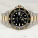daniel-hay-O703kpzIsQI-unsplash-a black and gold rolex watch on a white background