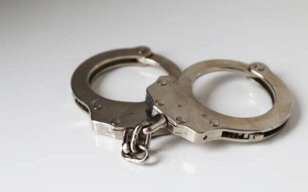 A single pair of closed handcuffs against a plain white background.