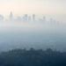 Thick layer of smog and haze from nearby brush fire obscuring the view of downtown Los Angeles buildings in Southern California