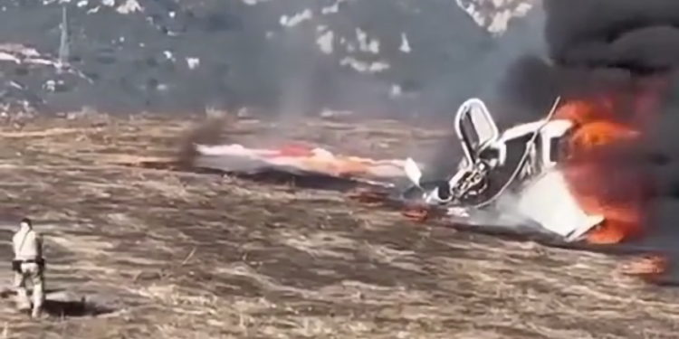 A California Highway Patrol officer pulls the pilot from a fiery plane crash in Goleta on Jan. 29, 2025. (Steve Epstein via CHP)