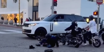 Two mini-bike riders are seen on the ground after running into an SUV in Beverly Hills