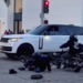 Two mini-bike riders are seen on the ground after running into an SUV in Beverly Hills