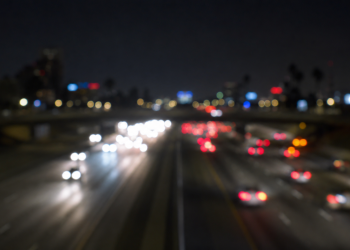 Blurred nighttime freeway traffic with out-of-focus headlights and taillights, used as an illustrative image for a fatal wrong-way crash on the 405 Freeway in Hawthorne.