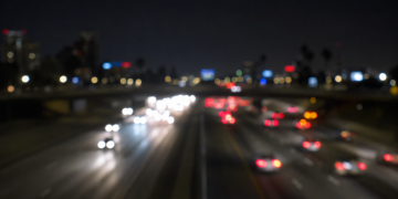 Blurred nighttime freeway traffic with out-of-focus headlights and taillights, used as an illustrative image for a fatal wrong-way crash on the 405 Freeway in Hawthorne.