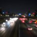 Blurred nighttime freeway traffic with out-of-focus headlights and taillights, used as an illustrative image for a fatal wrong-way crash on the 405 Freeway in Hawthorne.