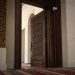 Close-up of mosque prayer rugs and a security camera near an entrance with no identifiable signage.