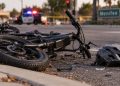 Close-up of a damaged e-bike near a Menifee roadway after a fatal police pursuit crash