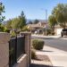 Close-up of a quiet Lancaster residential street with suburban homes, sidewalks and desert landscaping, illustrating a court-approved community placement.