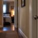 Close-up of an empty Ojai-area residence hallway with a closed bedroom door and blurred household details in the background, illustrating a sexual assault case.