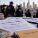 Close-up of grant paperwork and financial records illustrating a homelessness fraud investigation.