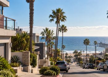 Coastal Southern California neighborhood near Hermosa Beach after a small earthquake, with palm trees, homes and the ocean visible in the background.
