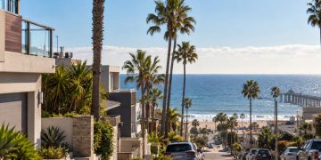 Coastal Southern California neighborhood near Hermosa Beach after a small earthquake, with palm trees, homes and the ocean visible in the background.