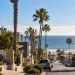 Coastal Southern California neighborhood near Hermosa Beach after a small earthquake, with palm trees, homes and the ocean visible in the background.