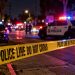 Long Beach police investigation scene at night near a residential street, with patrol vehicles and emergency lights blurred in the background.