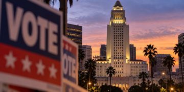 Los Angeles City Hall at dusk with a blurred campaign-style foreground, illustrating the 2026 Los Angeles mayoral race.