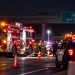 Nighttime emergency response on a Simi Valley freeway, with a fire engine, police vehicle, firefighters and traffic cones beneath an overpass.