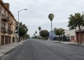 A street in South Los Angeles with older residential buildings and storefronts, photographed in neutral daylight, illustrating neighborhoods where homicides remain concentrated.