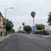 A street in South Los Angeles with older residential buildings and storefronts, photographed in neutral daylight, illustrating neighborhoods where homicides remain concentrated.