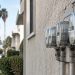 Close-up of a row of residential electric meters on a stucco wall in Los Angeles in neutral daylight, illustrating high LADWP summer bills.
