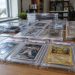 Close-up of graded sports and Pokémon trading cards sealed in clear plastic cases on a table in soft daylight, illustrating the Santa Ana FedEx truck theft.