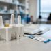Close-up of naloxone nasal spray devices and drug test strips on a clinic counter in neutral daylight, illustrating the Los Angeles County opioid warning.