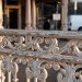 Close-up of ornate Victorian railings with weathered paint, with a blurred entrance behind, illustrating a historic nightclub venue closure.