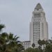 Los Angeles City Hall in neutral daylight, its tower sharp above softly blurred palm trees, illustrating a national city safety ranking.