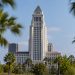 Los Angeles City Hall tower in daylight above softly blurred palm trees, illustrating the 2026 Los Angeles mayoral race.