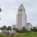 Los Angeles City Hall tower in neutral daylight, sharp above softly blurred palm trees in the foreground, illustrating the 2026 Los Angeles election.