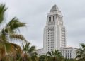 Los Angeles City Hall tower sharp in neutral daylight with softly blurred palm trees in the foreground, illustrating the 2026 Los Angeles mayoral race.