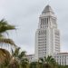 Los Angeles City Hall tower sharp in neutral daylight with softly blurred palm trees in the foreground, illustrating the 2026 Los Angeles mayoral race.